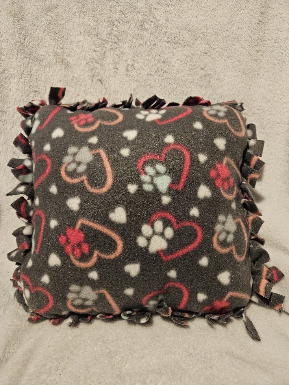 Handmade gray fleece accent pillow with paw prints and hearts. Machine Washable